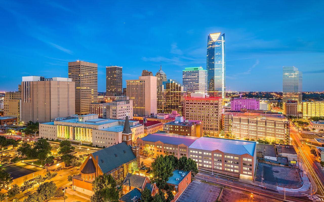 Downtown Oklahoma City skyline at dusk, with the Devon Energy Center lit up